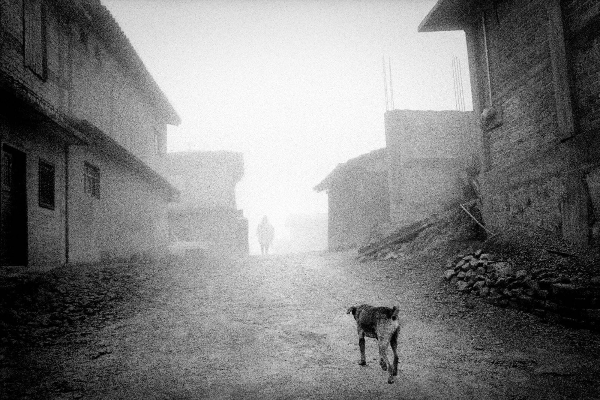 San Miguel Cuevas, Oaxaca. 2000. Fog drifts through deserted streets., 2000